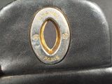 a close up of a black purse with a gold handle