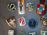 a lot of badges that are on a table