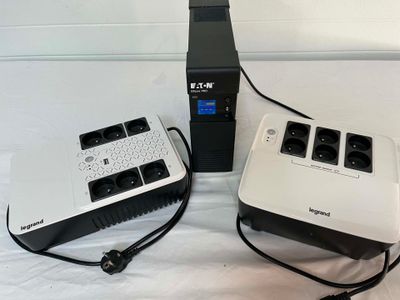 two power outlets and a charger on a bed