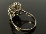 an image of a diamond ring on a black surface