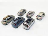 several toy cars are lined up in a row on a white surface