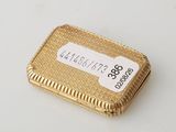 a gold box with a label on it on a table