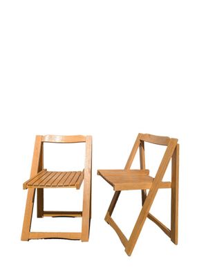 two wooden chairs sitting next to each other on a white background