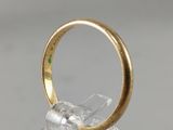a close up of a gold ring with a green stone in it