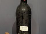 a bottle of wine sitting on a table with a cork stopper