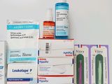 a pile of medicine and other medical supplies on a table