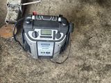 a radio that is sitting on the ground next to a fire hydrant