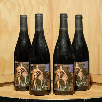 three bottles of wine sitting on top of a wooden barrel