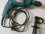 a drill and a cord are laying on a table