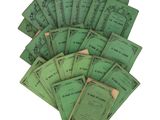 many green books are stacked on top of each other on a white surface