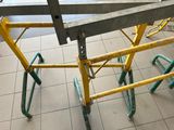 a yellow scaffolding on the floor of a subway station