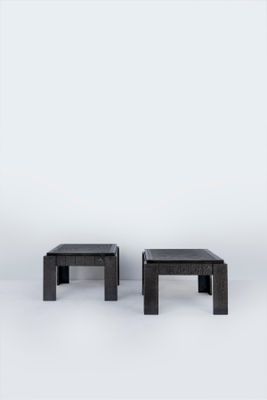 pair of black coffee tables on a white background with a white backdrop
