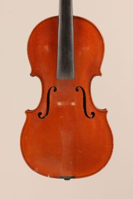 an old violin with a bow hanging from it ' s back