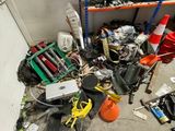 a pile of assorted items on the floor of a garage