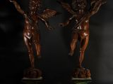 a pair of antique bronze statues of cherensils on marble bases