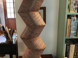 a tall sculpture made out of jute rope on a table