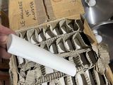 a person holding a white toothbrush in a box