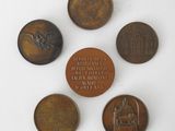 six bronze medals of various countries including a statue and a medal
