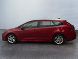 the red toyota corolla is parked in a large room