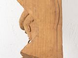 a piece of wood hanging from a hook on a wall