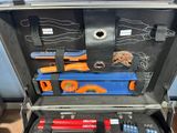 a suitcase with tools inside of it on the floor