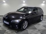 a picture of a black bmw car parked in a garage
