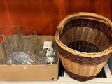 a wicker basket on a shelf next to a box of empty wine glasses