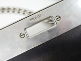 a black and silver purse with a chain around it