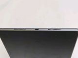 the back of a laptop computer sitting on top of a white table