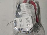 a bag with a red and white rope in it on a table