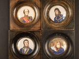 three framed portraits of a man and a woman on a wall