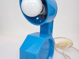 a blue lamp that is on a white table