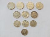a close up of a number of coins on a white surface