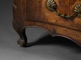 an antique chest of drawers with brass handles on a grey background