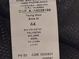 a label on a black jacket with a white tag on it
