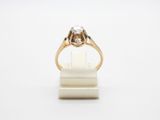 a gold and diamond ring on a white background