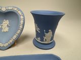 a blue vase and a blue tray with a picture of a man and a woman on it