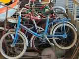 many bikes that are stacked up together in a garage