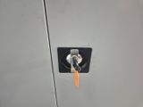 an image of a metal locker with a key in it