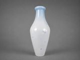a blue and white vase sitting on a gray surface