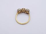 an image of a gold ring with three diamonds on it