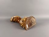 gold leaf candle holder on a grey surface
