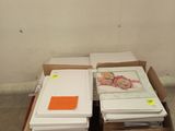 a lot of books on a carton in a room
