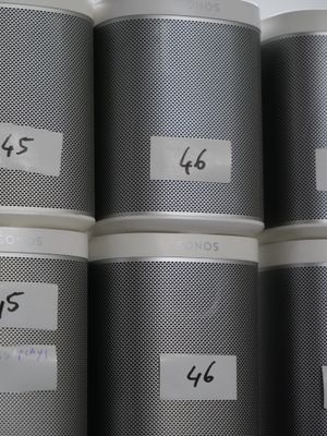 five tins with labels on them sitting on a shelf