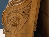 a wooden bench that has a carved design on it