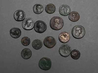 several ancient roman coins are arranged in a circle on a table