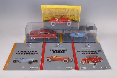 four toy cars in a display case on a table