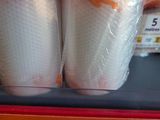 several rolls of toilet paper sitting on top of a shelf in a store