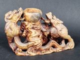 a figurine of two fish and a man on a rock