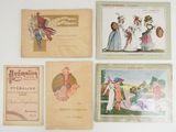 several old postcards of women ' s fashions are displayed on a table